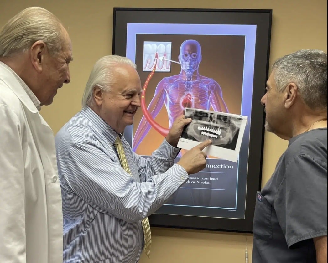 Multiple dental specialists collaboratively reviewing a complex dental reconstruction case, combining expertise in restorative dentistry, implant dentistry, prosthodontics, periodontics, bite analysis, TMJ evaluation, and comprehensive treatment planning to develop the most appropriate long-term treatment plan.